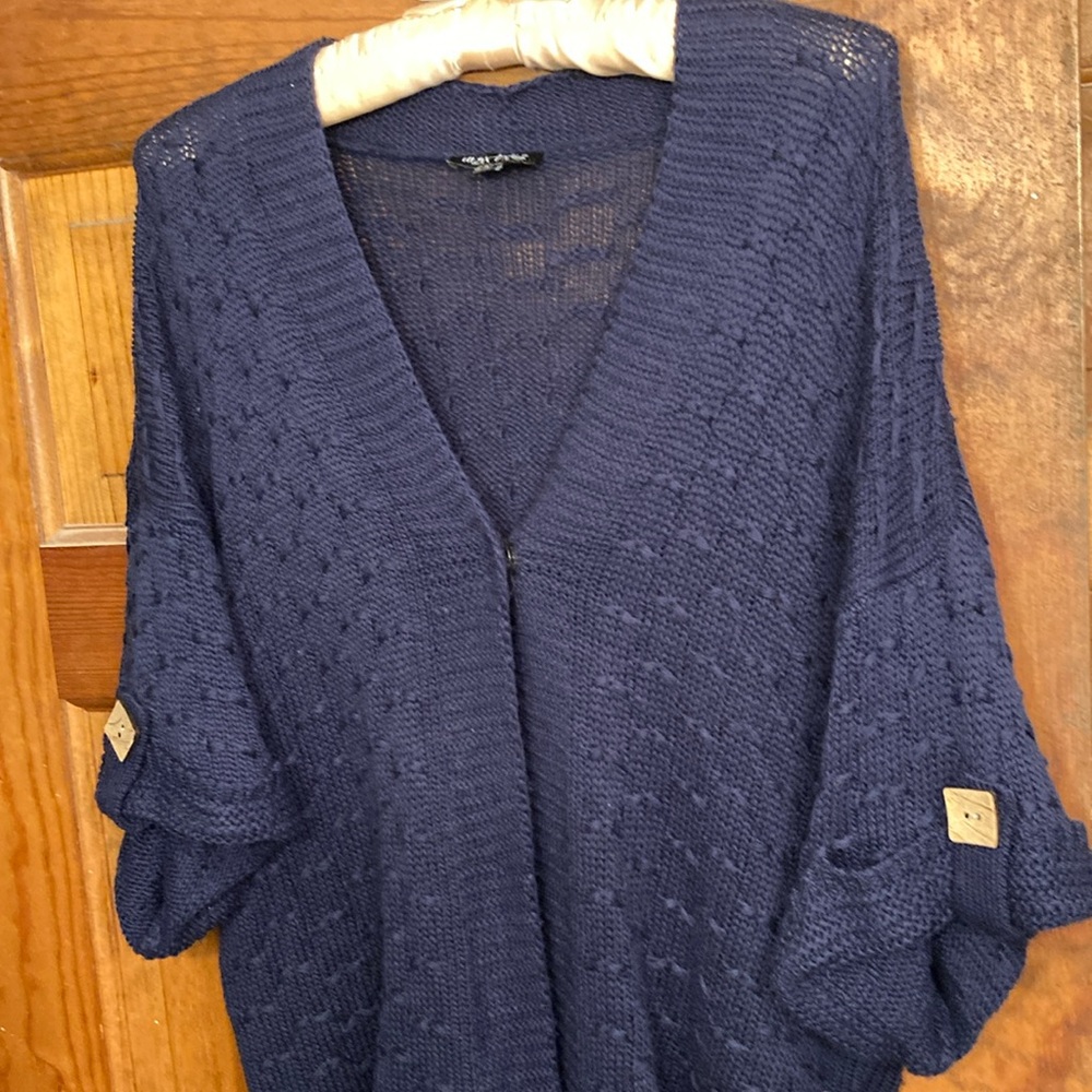 Sweater, shrug style with one large snap front closure. Roomy, stylish